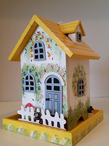 Garden Cottage Bird Feeder is decorated to compliment any patio garden this Wood Bird Feeder is hand painted with a Colorful Floral Print and a White Pickett Fence